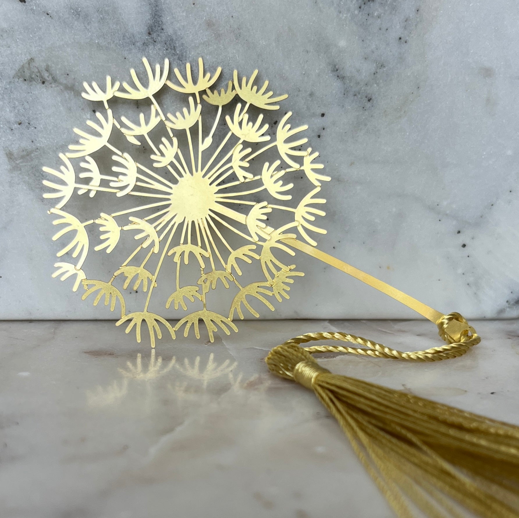 Gold metal dandelion bookmark with a tassel